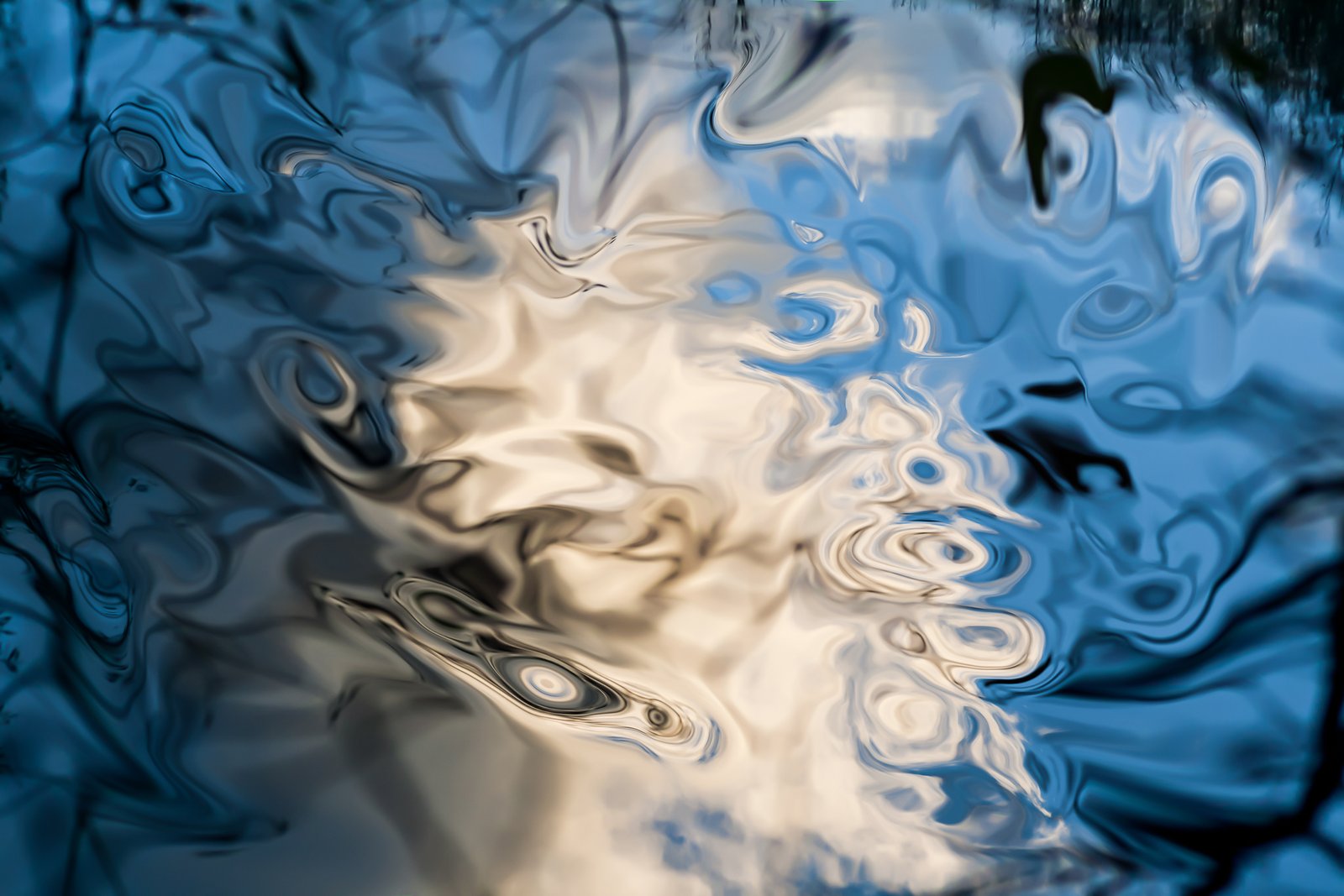 floating abstract reflections on smooth texture water with blue and white shades.